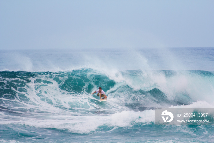 Surfer riding wave