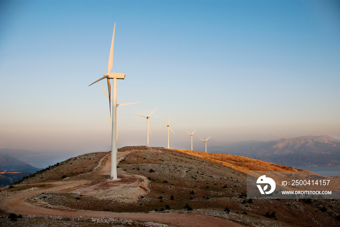 View of wind turbines on top of hill