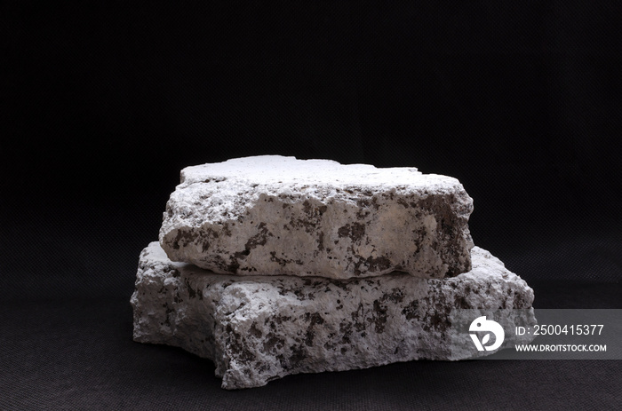 Closeup of two white stones on the dark surface.Empty space.Promotion stand