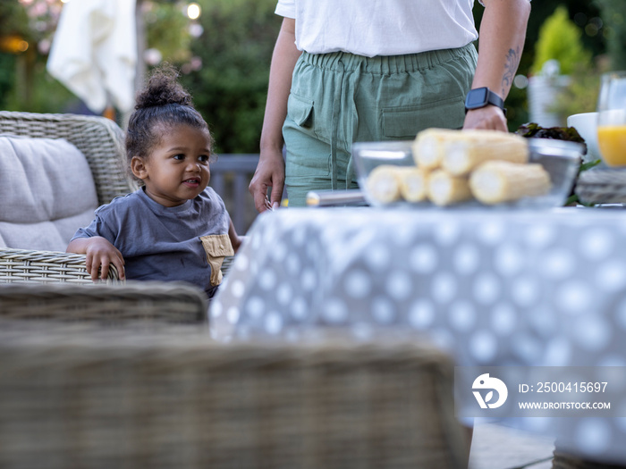 Woman with son (2-3) at outdoor table