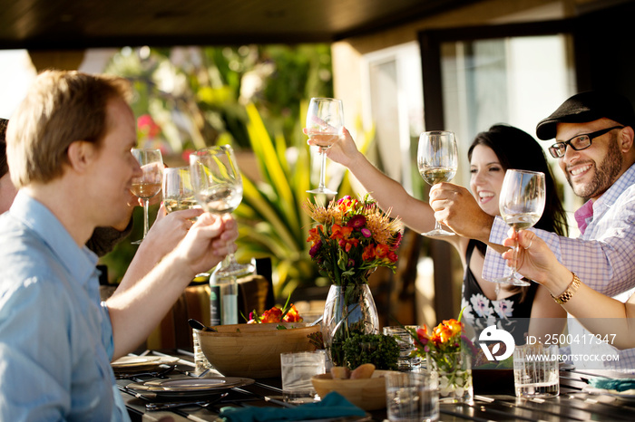 Friends toasting during lunch on patio