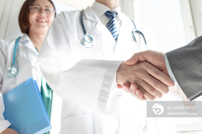 Doctor and business people shaking hands