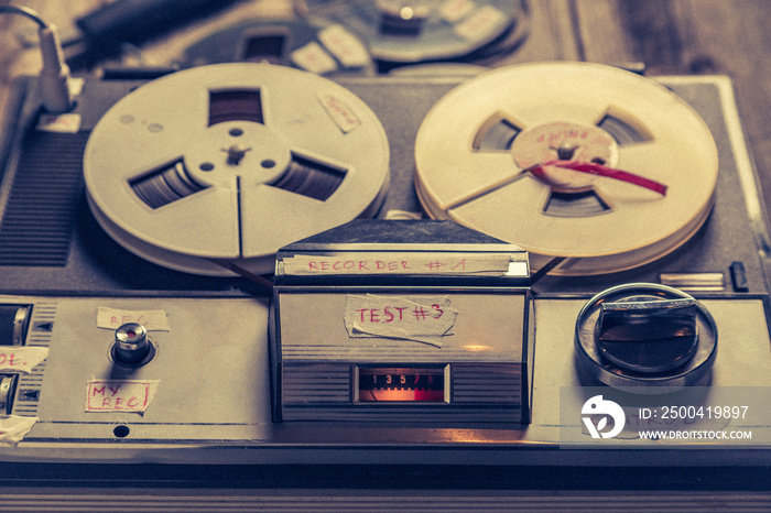 Vintage tape audio recorder with roll of tape and microphone