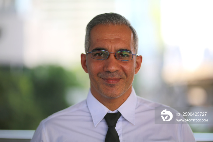 Head shot of business man with confident look at camera