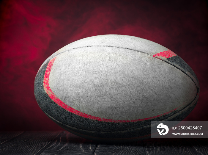 Old rugby ball on a red background