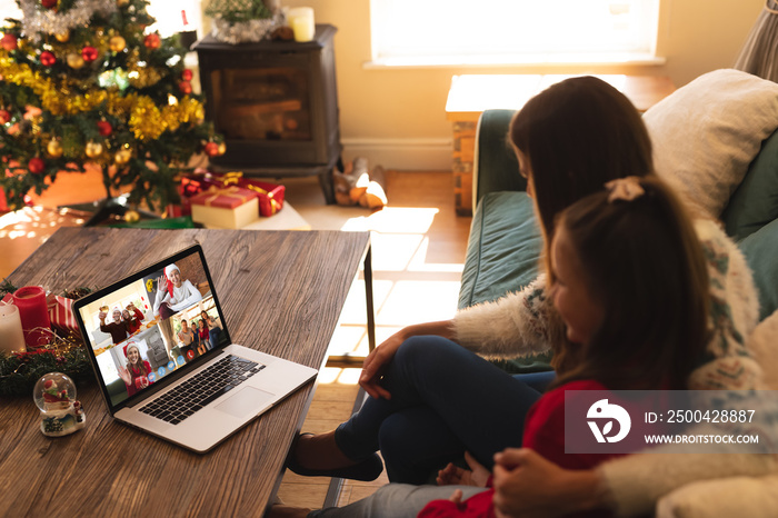 Caucasian woman with her daughter at christmas on a video call