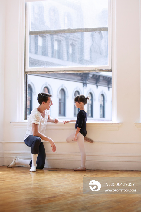 Girl talking to ballet teacher