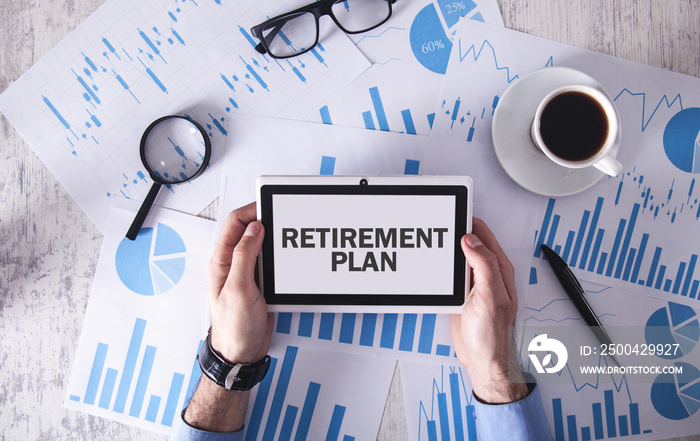 Man holding tablet with text Retirement Plan on tablet screen.