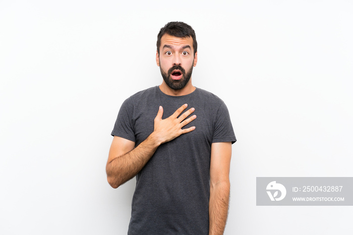 Young handsome man over isolated white background surprised and shocked while looking right