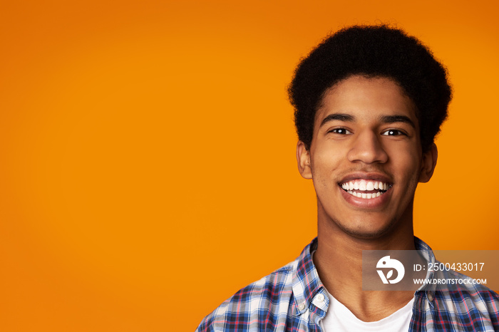 Teeth Whitening. Afro Guy Smiling Widely in Studio