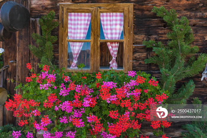 Window of traditional farmhouse with flowers