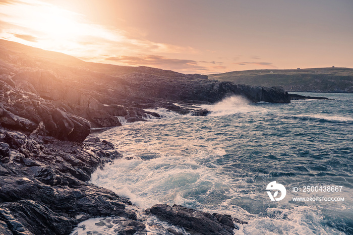 Sunrise over rough stone coast line. South of Ireland.