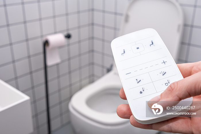 remote Control with buttons of the smart toilet bowl. high technology automatic modern flush toilet