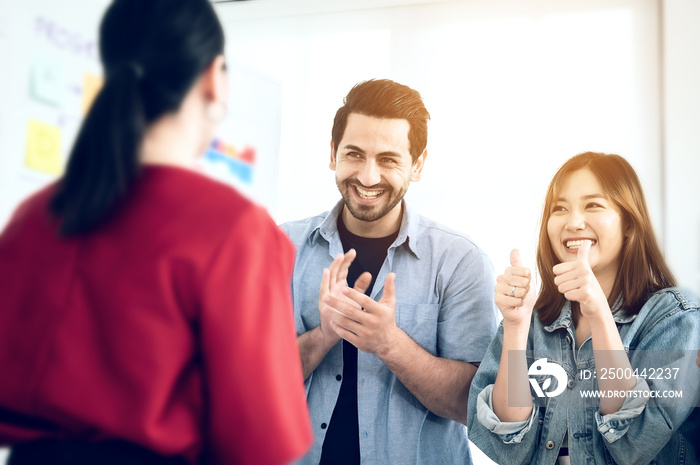 Happy group of business people clapping in office.  Male and female success entrepreneurs achieving 