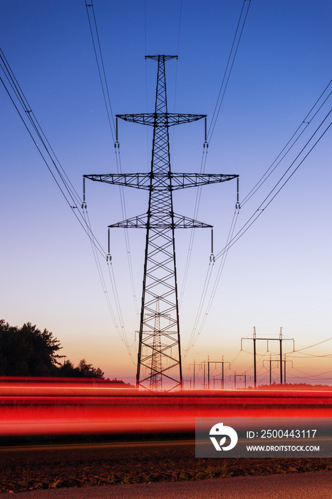 High voltage electricity pylon system and tracks from traffic.