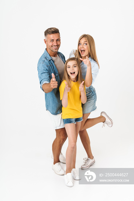 Full length photo of attractive family woman and man with little girl smiling and pointing fingers a