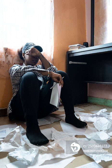 female artist frustrated and seating on the floor