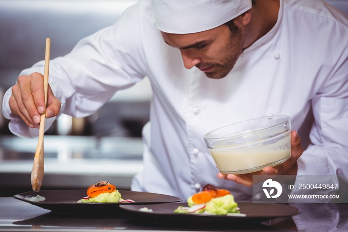 Chef putting sauce on a dish