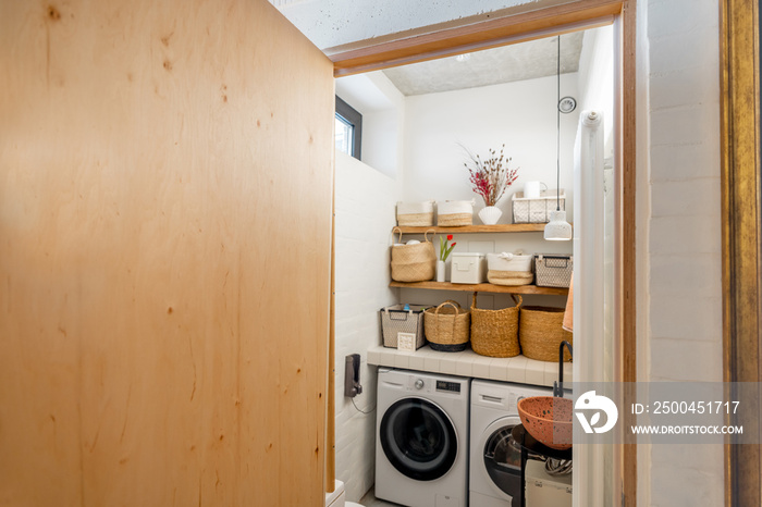 Home laundry with machines and clothes baskets