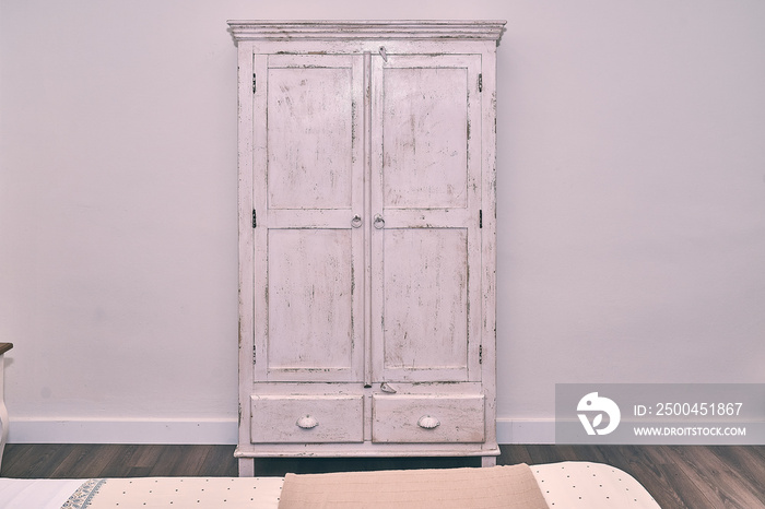 Grunge and white furniture in a bedroom