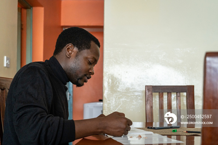 male artist sketching alone at home