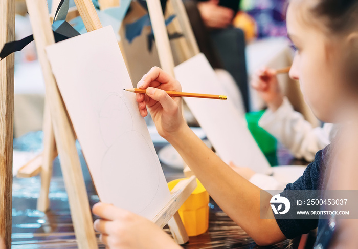 group lesson in drawing. Children learn to draw in the classroom.