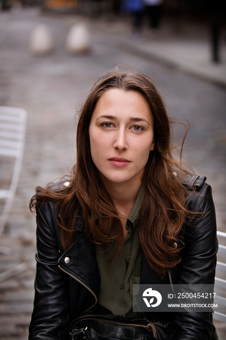 Portrait of young woman sitting outdoors