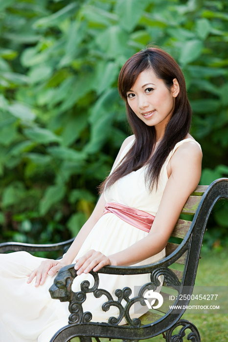 Woman sitting on park bench, Frankfurt, Germany