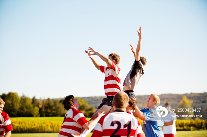 Rugby players playing match in field