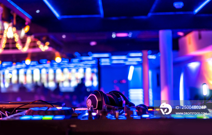 Headphones on the dj turntable in the night club, copy space