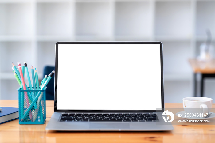 Laptop white blank screen with a coffee cup placed on a wooden coffee shop . Mock up.