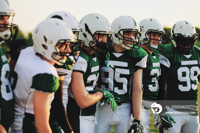 American football team standing together on a field during pract