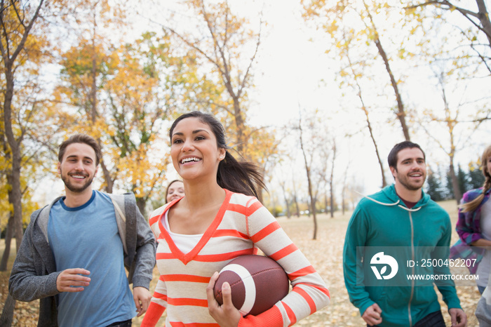 Friends playing football at park