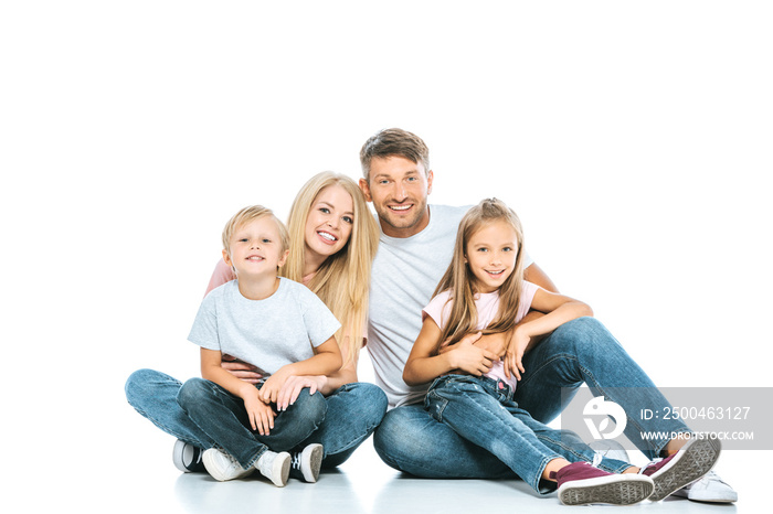 happy parents and kids in blue jeans sitting on white