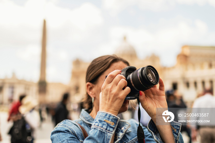 Female brunette tourist photographing architecture of an italian