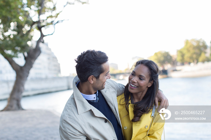 Affectionate couple hugging at Seine River, Paris, France