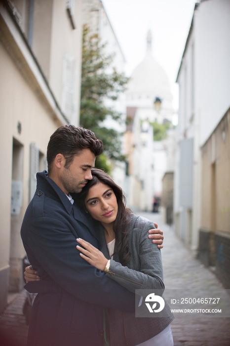 Affectionate couple hugging on Montmartre street, Paris, France