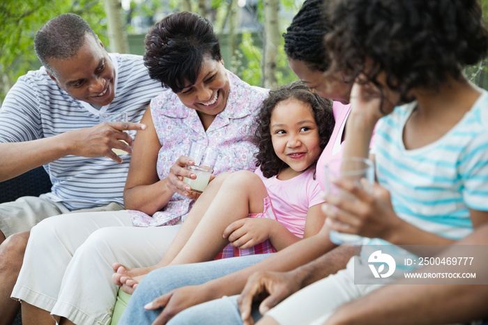 Multi-generation family enjoying lemonade outdoors