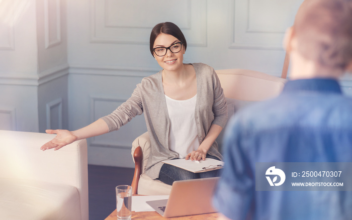 Cheerful school psychologist going to talk with a teen boy