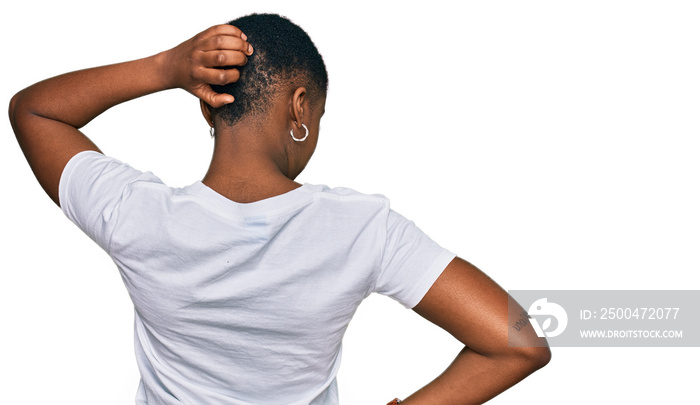 Young african american woman wearing casual white t shirt backwards thinking about doubt with hand o