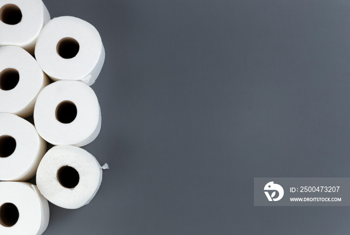 Toilet paper rolls on grey background. Overhead flat lay format with copy space. Hoarding concept fo