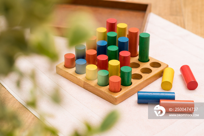 Top view closeup of colorful wooden Montessori sensorial material learning, Sizing and order block. 