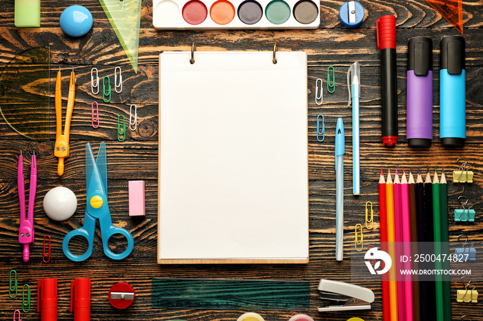 Different school stationery on wooden background