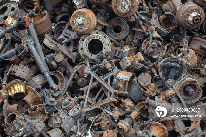 Old and rusty automotive parts are stacked together. Old and rusty iron scrap.