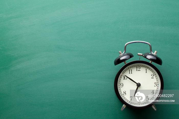 alarm clock on chalkboard