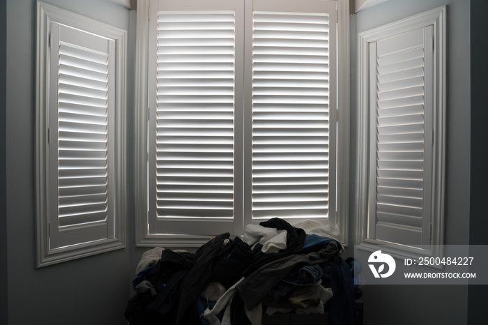 black and white window with shutters in a bedroom with a white background