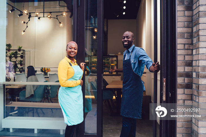 Black waiters inviting customers to cafe