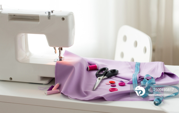 sewing machine, scissors, buttons and fabric