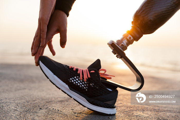 Close up of disabled athlete woman with prosthetic leg