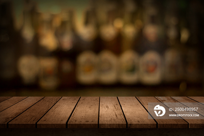 Wooden table with a view of blurred beverages bar bottle background. For create montage product disp